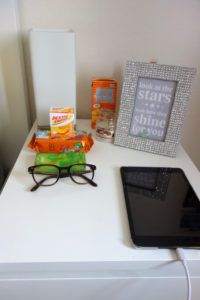 nightstand: lamp, ipad, glasses, snacks